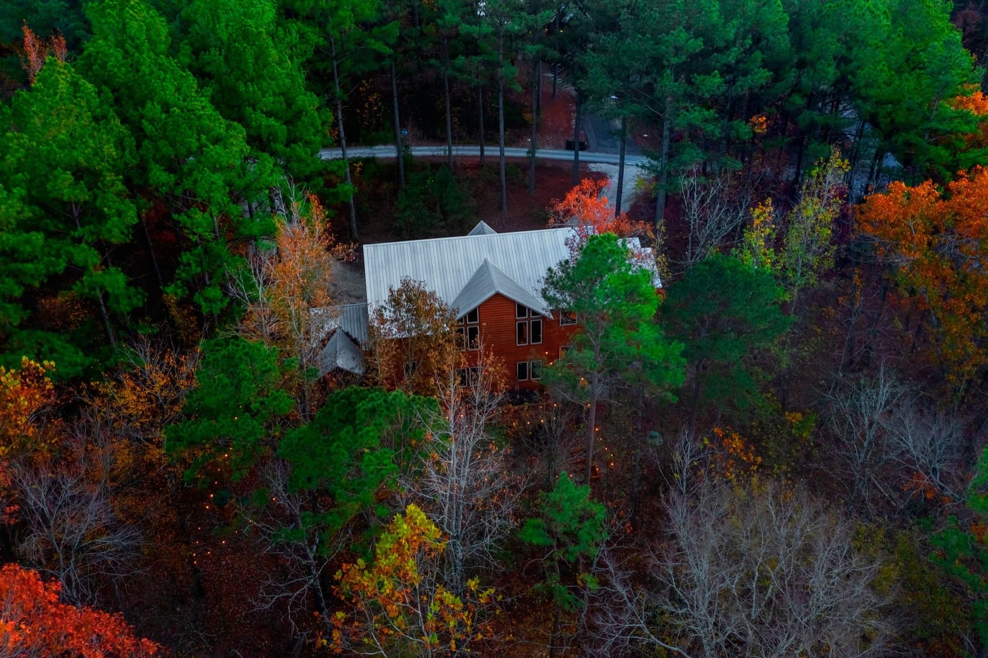 Aerial view of The Ocho cabin nestled in the fall-color Ouachita pine forest near Hochatown and Beavers Bend, Broken Bow, OK